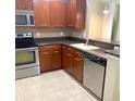 Well-lit kitchen featuring wooden cabinets and stainless steel appliances at 2669 Sicily Dr, New Smyrna Beach, FL 32168