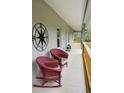 Inviting covered porch featuring rocking chairs and decorative compass at 2995 Ragis Rd, Edgewater, FL 32132