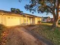 Home exterior featuring a one car garage and a mature shade tree at 309 Sea Hawk Ct, Edgewater, FL 32141