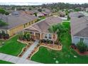 Beautiful aerial shot of a single-story home with manicured lawn and landscape design in a quiet neighborhood at 3368 Tuscano Ne Ave, New Smyrna Beach, FL 32168