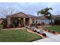 Inviting home exterior with lush landscaping, stone accents, and walkway at 3368 Tuscano Ne Ave, New Smyrna Beach, FL 32168