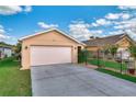 Attached two car garage with concrete driveway and manicured lawn in a well maintained neighborhood at 3368 Tuscano Ne Ave, New Smyrna Beach, FL 32168