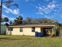 The backyard of this cozy home features a well-maintained lawn and a covered porch at 434 Palmetto St, Edgewater, FL 32132