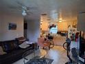 Cozy living room with leather sofa, glass table, and open view to the kitchen at 434 Palmetto St, Edgewater, FL 32132