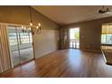 Bright dining area with chandelier, wood floors, sliding doors to patio, and neutral wall color at 45 Sandra Cir, New Smyrna Beach, FL 32168