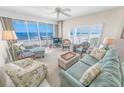 Bright living room boasting ocean views from the balcony, comfortable seating, and beachy decor at 4767 S Atlantic Ave # 404, Ponce Inlet, FL 32127