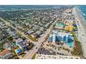 Wide aerial view capturing the neighborhood, beach, and surrounding areas at 604 S Atlantic Ave, New Smyrna Beach, FL 32169