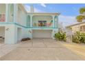 Coastal home showcasing a garage, balcony, and inviting architecture in a vibrant neighborhood at 604 S Atlantic Ave, New Smyrna Beach, FL 32169