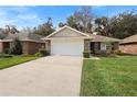 Charming single-story home with a well-manicured lawn and a two-car garage at 634 Coral Trace Blvd, Edgewater, FL 32132