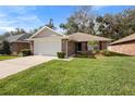 Charming single-story home with a well-manicured lawn and a two-car garage at 634 Coral Trace Blvd, Edgewater, FL 32132