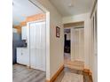 Hallway shows hardwood laminate flooring, wood trim and decorative white louvered doors at 704 Hillville Dr, Port Orange, FL 32127