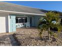 Inviting front porch with charming swing, white chairs, and a well-manicured garden, enhancing the home's curb appeal at 86 Rains Ct, Ponce Inlet, FL 32127