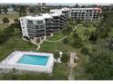 A beautiful building aerial view features a pool, landscaping and easy access to the beach in New Smyrna Beach, Florida at 944 S Peninsula Dr # 5010, Daytona Beach, FL 32118