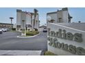 Exterior shot of Indies House sign with palm trees and parking lot at 1275 Ocean Shore Blvd # 5050, Ormond Beach, FL 32176