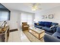 Cozy living room featuring tile flooring, comfortable seating, and ample natural light at 1818 Enterprise Ave # B, New Smyrna Beach, FL 32168