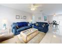 Inviting living area with tile floors, ceiling fan, and nautical-themed decorations at 1818 Enterprise Ave # B, New Smyrna Beach, FL 32168