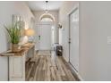 Inviting foyer with wood-look floors, natural light, and stylish console table at 1880 1St Ave, Deland, FL 32724