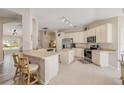 Open kitchen with white cabinets, stainless steel appliances, and a breakfast bar area at 1880 1St Ave, Deland, FL 32724