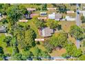 Expansive property featuring a main house, guest house, in-law house, art studio, garage, storage sheds, and a beautiful landscape at 191 Howes St, Oak Hill, FL 32759