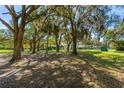 Expansive property showcasing multiple residences surrounded by mature trees and verdant lawns at 191 Howes St, Oak Hill, FL 32759