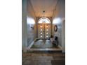 Inviting entryway features beautiful tile flooring, elegant lighting, and a comfortable bench at 1948 Spruce Creek Lndg, Port Orange, FL 32128