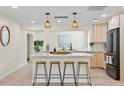 Beautiful modern kitchen with hardwood floors, light cabinets, and a large center island at 20 Warwick Ave, Ormond Beach, FL 32174