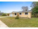 Charming single-story home with a well-manicured lawn and attached two car garage at 2211 Brian Ave, South Daytona, FL 32119