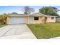 Charming one-story home featuring a well-maintained lawn and attached two car garage at 2211 Brian Ave, South Daytona, FL 32119