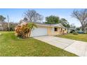 Charming one-story home with a well-manicured lawn and attached two car garage at 2211 Brian Ave, South Daytona, FL 32119