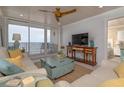 Living room with comfortable seating, stylish decor, and balcony access with ocean view at 2401 S Atlantic Ave # A604, New Smyrna Beach, FL 32169