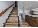 Beautiful entryway with wood stairs, wood flooring and direct access to the kitchen at 2401 S Atlantic Ave # D301, New Smyrna Beach, FL 32169