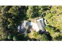 Stunning aerial view showcases a home surrounded by lush greenery, featuring ample parking and serene privacy at 2576 Shilo Glynn Ln, New Smyrna Beach, FL 32168