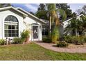 Close up exterior featuring a well-manicured lawn and pathway leading to the home's entrance at 2576 Shilo Glynn Ln, New Smyrna Beach, FL 32168