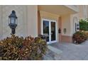 Inviting building entrance featuring double doors, stone accents, and decorative lighting at 265 Minorca Beach Way # 505, New Smyrna Beach, FL 32169