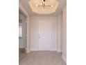 Inviting foyer with modern lighting and tile flooring leading into the home's interior at 265 Minorca Beach Way # 505, New Smyrna Beach, FL 32169