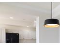 Kitchen with modern light fixture, white cabinets, granite countertops, and stainless steel appliances at 265 Minorca Beach Way # 505, New Smyrna Beach, FL 32169