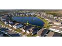 Stunning aerial view of a lakeside home in a well-planned community with a tranquil lake at 2820 Neverland Dr, New Smyrna Beach, FL 32168