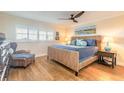 Comfortable bedroom with wood floors, wicker furniture, and bright natural light at 315 N Causeway # C402, New Smyrna Beach, FL 32169