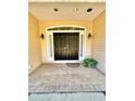 Welcoming front porch with a double-door entry and brick flooring accented by flower pot at 3435 Black Willow Trl, Deland, FL 32724