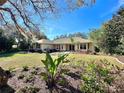 Charming home with a well-manicured lawn and colorful landscaping under a bright blue sky at 3435 Black Willow Trl, Deland, FL 32724