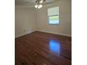 Bedroom with hardwood flooring, a ceiling fan, and a window offering natural light at 36 Fairway Ct # 36, Deland, FL 32724