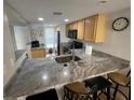 Updated kitchen featuring granite countertops and stainless steel appliances at 3801 S Atlantic Ave # Ut125, New Smyrna Beach, FL 32169