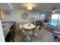 Open-concept living room with dining area and access to the outdoors at 3801 S Atlantic Ave # Ut125, New Smyrna Beach, FL 32169