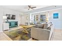 Cozy living room with tile flooring, modern furnishings and large windows letting in plenty of natural light at 5300 S Atlantic Ave # 3-301, New Smyrna Beach, FL 32169