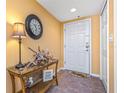 Inviting entryway featuring a decorative table, stylish lamp, and a welcoming atmosphere at 5300 S Atlantic Ave # 7-307, New Smyrna Beach, FL 32169