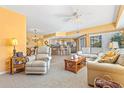 Open-concept living room connected to kitchen, featuring neutral tones, comfortable seating, and natural light at 5300 S Atlantic Ave # 7-307, New Smyrna Beach, FL 32169