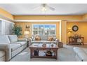 Well-lit living room features comfortable seating, stylish decor, and large windows with neighborhood view at 5300 S Atlantic Ave # 7-307, New Smyrna Beach, FL 32169