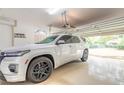 Clean garage with a late-model SUV parked inside and access to the home and driveway at 6049 Sabal Hammock Cir, Port Orange, FL 32128