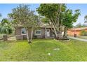 Charming home boasts mature trees, providing shade and enhancing curb appeal at 612 Cedar Park Dr, Daytona Beach, FL 32114