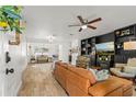 Spacious living room with tile floors, a ceiling fan, and built in shelving at 612 Cedar Park Dr, Daytona Beach, FL 32114